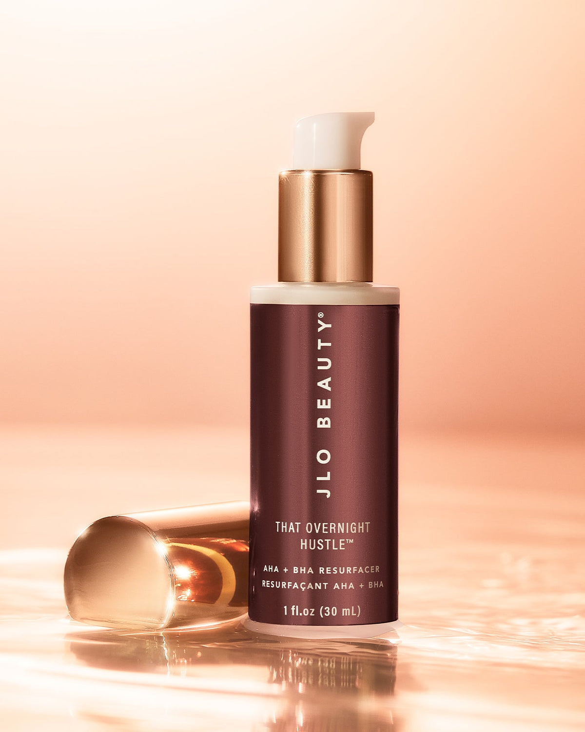 AHA-BHA bottle with dropper on a warm peach backdrop.