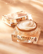 Open Eye Cream jar arranged on a warm gold backdrop.