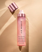 Glow Mist bottle lit by warm gold light.