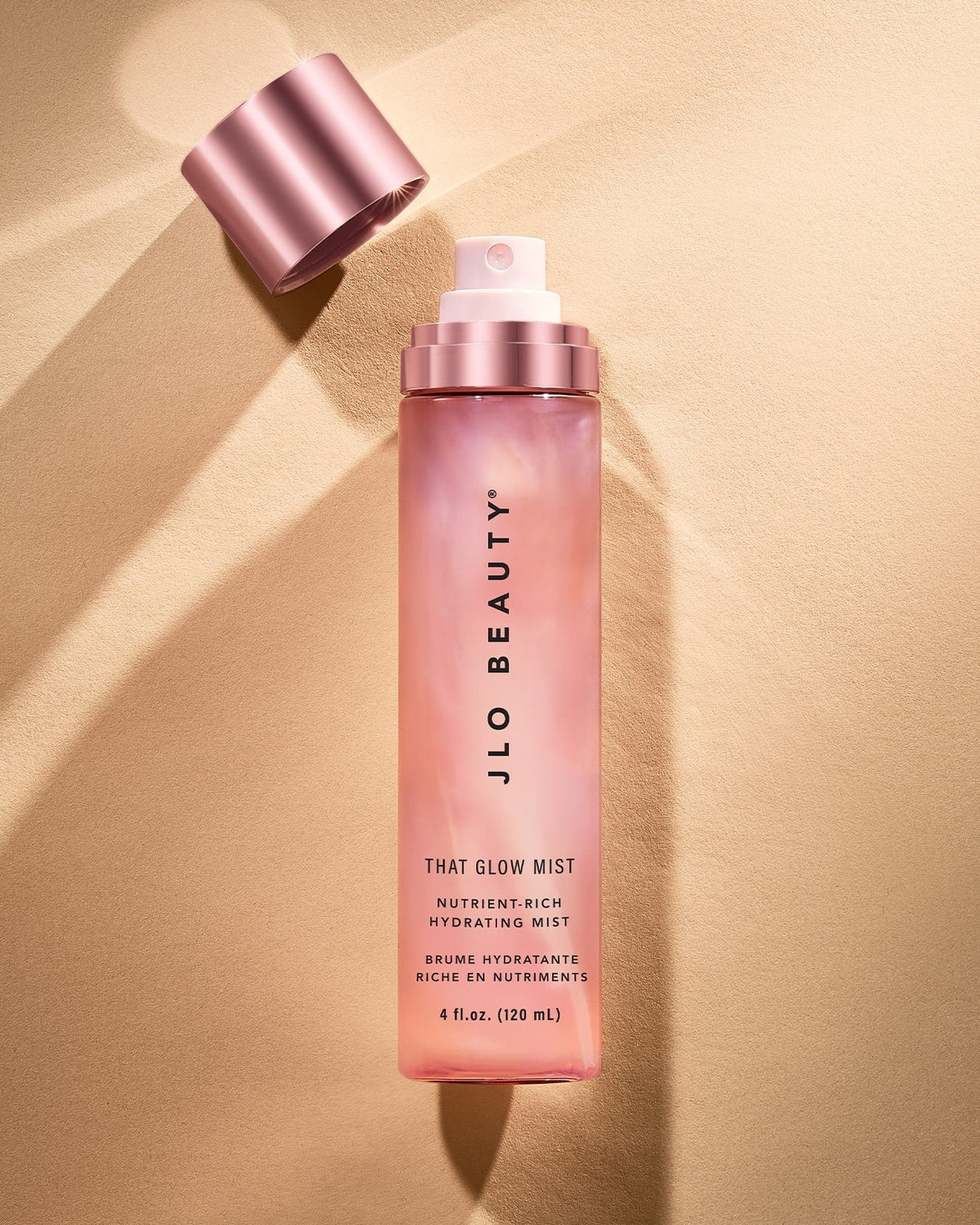 Glow Mist bottle lit by warm gold light.