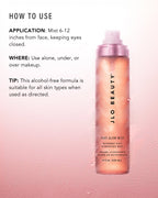 JLO Beauty Glow Mist bottle lit by warm gold light, with Heading How to Use. 