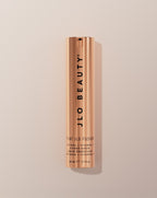 JLO Beauty That JLO Fusion Retinal + Vitamin C Power Serum in a sleek, metallic rose gold cylindrical bottle