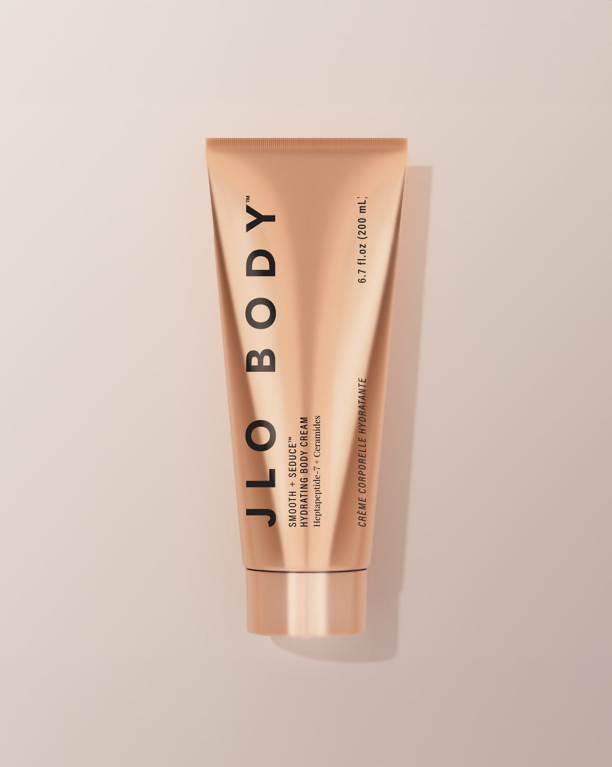 JLO BODY Hydrating BodyCream in a metallic rose gold squeeze tube