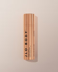 JLO BODY Ultimate Body Serum in a sleek metallic rose gold cylindrical bottle