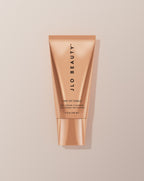 JLO Beauty Cleanser tube on a neutral background.