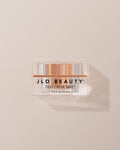 JLO Beauty Eye Cream jar on a neutral background.