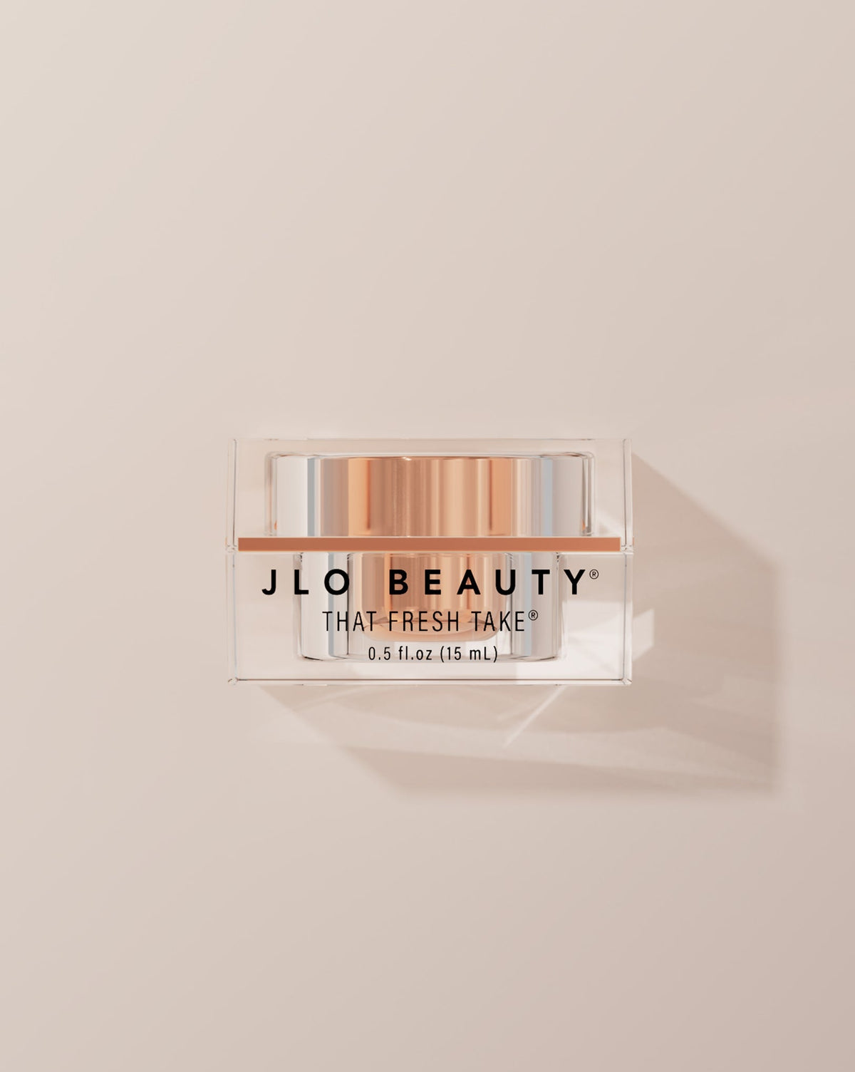 JLO Beauty Eye Cream jar on a neutral background.