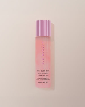 JLO Beauty Glow Mist bottle in soft pink on a neutral background.