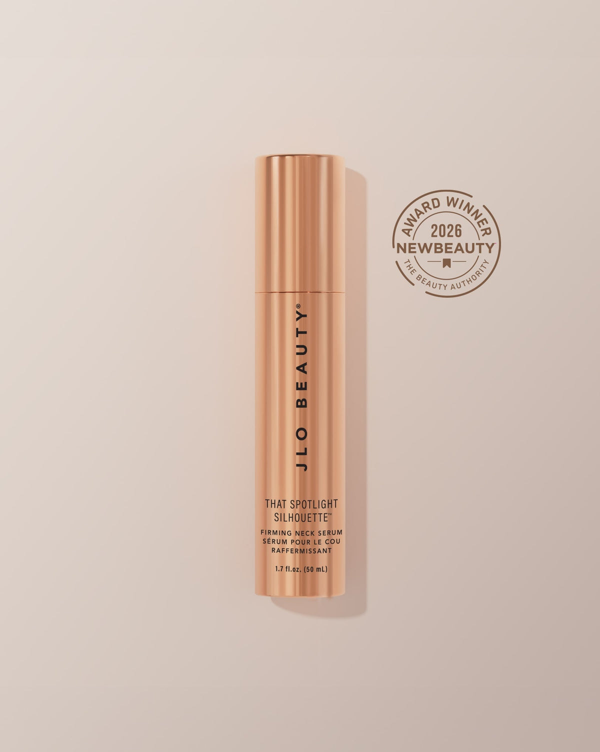 JLO Beauty That Spotlight Silhouette Retinol Night Cream in a metallic rose gold tube with a bronze award badge on the right reading '2026 New Beauty Award Winner'.