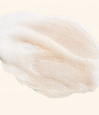A close up cosmetic texture shot of a milky small bubble lather.