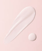 White cream smear and drop on a pink background