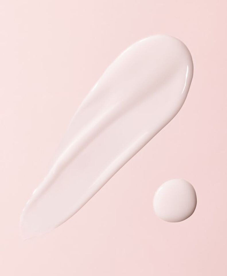 White cream smear and drop on a pink background