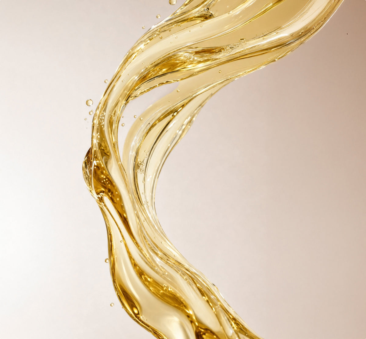 A close-up, soft-focus shot of a translucent, pale yellow liquid.